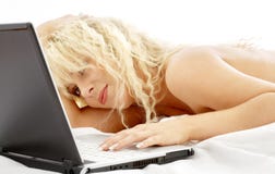 Portrait of blond laying in bed with laptop