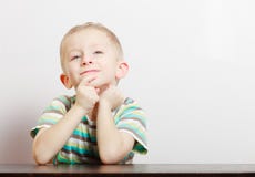 Portrait blond pensive thoughtful boy child kid at the table indoor royalty free stock image Portrait blond pensive thoughtful boy child kid at the table indoor royalty free stock image