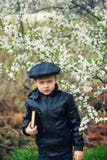 Portrait of a boy with a book in the spring blooming garden royalty free stock photos Portrait of a boy with a book in the spring blooming garden royalty free stock photos