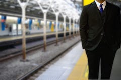 Portrait of a businessman standing on a platform of a train stat stock photo Portrait of a businessman standing on a platform of a train stat stock photo