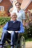 Portrait Of Carer Pushing Senior Man In Wheelchair royalty free stock image Portrait Of Carer Pushing Senior Man In Wheelchair royalty free stock image