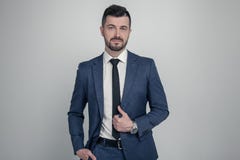 Portrait of a charming mature business man dressed in suit posing while standing and looking at camera isolated over gray royalty free stock images Portrait of a charming mature business man dressed in suit posing while standing and looking at camera isolated over gray royalty free stock images