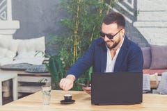 Portrait of cheerful freelancer at the desk in coffee shop. stock photo Portrait of cheerful freelancer at the desk in coffee shop. stock photo