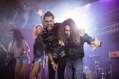 Portrait of cheerful male musicians on stage during music festival stock photos Portrait of cheerful male musicians on stage during music festival stock photos