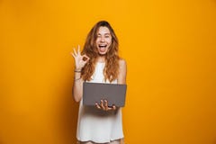 Portrait of a cheerful young girl holding laptop computer royalty free stock photo Portrait of a cheerful young girl holding laptop computer royalty free stock photo