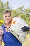 Portrait of confident gardener carrying sack in plant nursery royalty free stock photo Portrait of confident gardener carrying sack in plant nursery royalty free stock photo