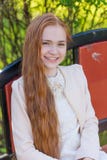 Portrait of a cute girl with long red hair in the park stock photos Portrait of a cute girl with long red hair in the park stock photos