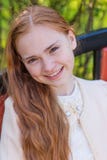 Portrait of a cute girl with long red hair in the park royalty free stock images Portrait of a cute girl with long red hair in the park royalty free stock images