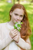 Portrait of a cute girl with long red hair in the park stock image Portrait of a cute girl with long red hair in the park stock image
