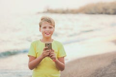 Portrait of cute happy smiling white kid using modern smart phone royalty free stock photo Portrait of cute happy smiling white kid using modern smart phone royalty free stock photo