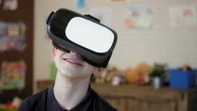 Portrait of a cute little boy wearing virtual reality headset stock video Portrait of a cute little boy wearing virtual reality headset stock video