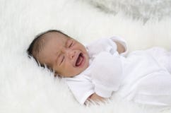 Portrait of cute newborn baby sleeping on white blanket stock photo Portrait of cute newborn baby sleeping on white blanket stock photo