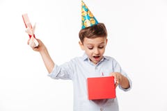 Portrait d'un petit enfant mignon enthousiaste dans un chapeau d'anniversaire photos stock Portrait d'un petit enfant mignon enthousiaste dans un chapeau d'anniversaire photos stock