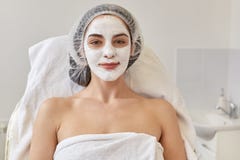 Portrait de femme satisfaisante dans le chapeau jetable et avec le masque sur le visage, regardant la caméra et le sourire La fem images libres de droits Portrait de femme satisfaisante dans le chapeau jetable et avec le masque sur le visage, regardant la caméra et le sourire La fem images libres de droits