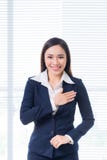 Portrait de sourire de femme d'affaires dans la fenêtre se tenante prêt de bureau Photo stock Portrait de sourire de femme d'affaires dans la fenêtre se tenante prêt de bureau Photo stock