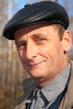 Portrait of elderly man in black hat in wood stock photography Portrait of elderly man in black hat in wood stock photography