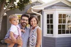 Portrait Of Excited Family Standing Outside New Home stock photos Portrait Of Excited Family Standing Outside New Home stock photos