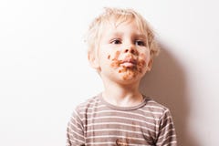 Boy eated chocolate, funny dirty smiled face royalty free stock photography Boy eated chocolate, funny dirty smiled face royalty free stock photography