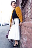 Portrait fashion woman walking on street . She wears yellow jacket, smiling to side. stock images Portrait fashion woman walking on street . She wears yellow jacket, smiling to side. stock images
