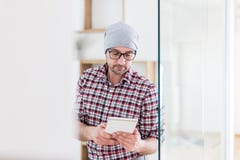 Portrait of fashionable architect or designer with tablet device standing at the office royalty free stock image Portrait of fashionable architect or designer with tablet device standing at the office royalty free stock image