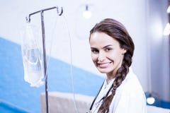 Portrait of female doctor carrying saline stand royalty free stock photo Portrait of female doctor carrying saline stand royalty free stock photo
