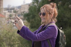 Portrait of a female tourist taking a photo on her smartphone stock photography Portrait of a female tourist taking a photo on her smartphone stock photography