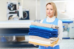 Portrait of a girl Laundry worker holding a clean towel Royalty Free Stock Image Portrait of a girl Laundry worker holding a clean towel Royalty Free Stock Image