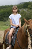 Portrait of a girl riding a brown horse. Walk in nature stock photos Portrait of a girl riding a brown horse. Walk in nature stock photos