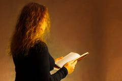 Portrait of a girl in a scarf in a black jacket on a dark background. stock photos Portrait of a girl in a scarf in a black jacket on a dark background. stock photos