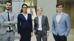 Portrait of group of business people smiling in modern office. Team of businessmen and businesswomen standing together stock video footage Portrait of group of business people smiling in modern office. Team of businessmen and businesswomen standing together stock video footage
