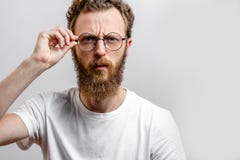 Portrait of handsome young serious man touching glasses stock photography Portrait of handsome young serious man touching glasses stock photography