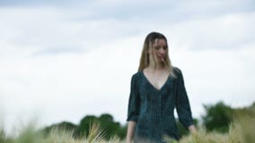 Portrait of a happy attractive caucasian blond girl with wet hair during rain on nature. The girl turns on the camera stock video footage Portrait of a happy attractive caucasian blond girl with wet hair during rain on nature. The girl turns on the camera stock video footage
