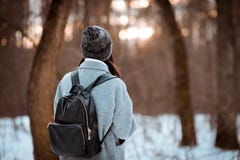 Portrait of a happy beautiful girl with brown hair in the winter forest dressed in a hipster style, lifestyle royalty free stock photography Portrait of a happy beautiful girl with brown hair in the winter forest dressed in a hipster style, lifestyle royalty free stock photography