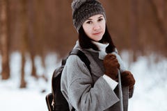 Portrait of a happy beautiful girl with brown hair in the winter forest dressed in a hipster style, lifestyle royalty free stock photos Portrait of a happy beautiful girl with brown hair in the winter forest dressed in a hipster style, lifestyle royalty free stock photos