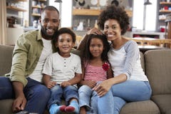 Portrait Of Happy Family Sitting On Sofa In Open Plan Lounge royalty free stock images Portrait Of Happy Family Sitting On Sofa In Open Plan Lounge royalty free stock images