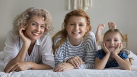 Portrait of happy multigenerational family spend time together at home