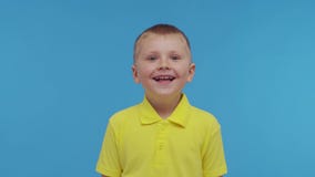 Portrait of happy smiling boy in t-shirt. Attractive and expressive kid in studio.