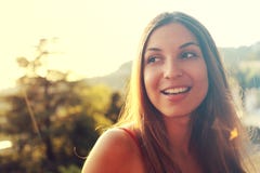 Portrait of happy smiling woman standing on sunny summer or spring day outside. Cute smiling woman looking to the side filtered i stock photo Portrait of happy smiling woman standing on sunny summer or spring day outside. Cute smiling woman looking to the side filtered i stock photo