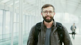 Portrait of happy tourist, bearded man smiling at the airport stock video Portrait of happy tourist, bearded man smiling at the airport stock video