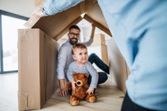 A portrait of young family with a toddler girl, moving in new home concept. royalty free stock image A portrait of young family with a toddler girl, moving in new home concept. royalty free stock image
