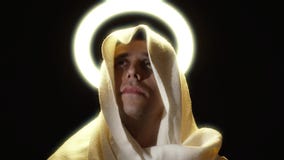 Holy man in a cape with a halo above his head
