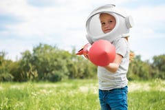 portrait of kid in cosmonaut helmet with rocket in hands standing royalty free stock photography portrait of kid in cosmonaut helmet with rocket in hands standing royalty free stock photography