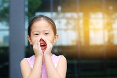 Portrait little Asian child girl acting and shouting through hands like megaphone. Communication concept stock image Portrait little Asian child girl acting and shouting through hands like megaphone. Communication concept stock image
