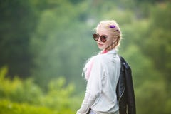 Portrait of little beautiful stylish kid girl on green forest background royalty free stock image Portrait of little beautiful stylish kid girl on green forest background royalty free stock image
