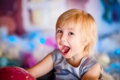Portrait of little blonde smiling girl playing with toy candy. Christmas and New Year theme stock photo Portrait of little blonde smiling girl playing with toy candy. Christmas and New Year theme stock photo