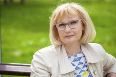 Portrait of lovely middle aged woman in the summer park royalty free stock photo Portrait of lovely middle aged woman in the summer park royalty free stock photo