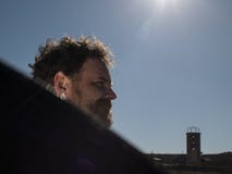 Portrait of a man with a beard and mustache holding a reflector in front of the sun stock photo Portrait of a man with a beard and mustache holding a reflector in front of the sun stock photo