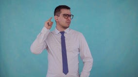 Portrait man with hearing impairment with a hearing aid on a blue background stock video footage Portrait man with hearing impairment with a hearing aid on a blue background stock video footage