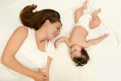 Portrait of mother and baby lie on white Stock Photos Portrait of mother and baby lie on white Stock Photos
