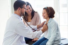 Mother with her daughter being examined with stethoscope by pediatrician. Royalty Free Stock Images Mother with her daughter being examined with stethoscope by pediatrician. Royalty Free Stock Images